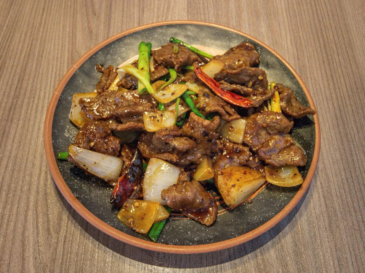 Savory stir-fried beef with onions & scallions at Uncle Qwik Chinese & Dumpling Restaurant, a Chinese Restaurant in Scottsdale